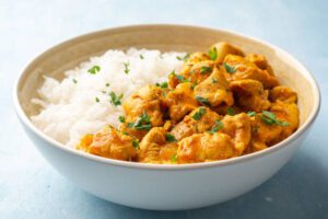 Chicken curry with rice in bowl.