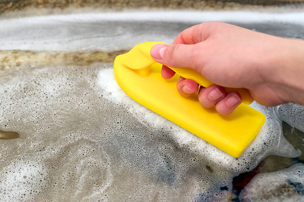 washing a carpet with a dish soap and water