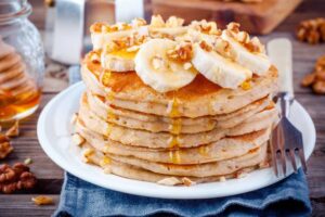Breakfast oatmeal pancakes with banana, walnuts and honey